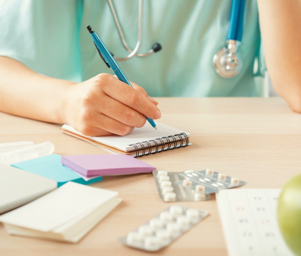 female-medicine-doctor-filling-patient-medical-form-or-prescription.jpg